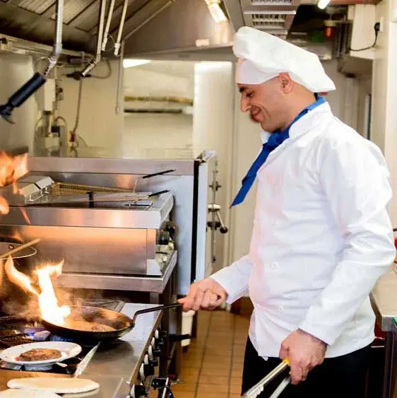 Summerville Estates Chef Created Meals, chef frying a dish.