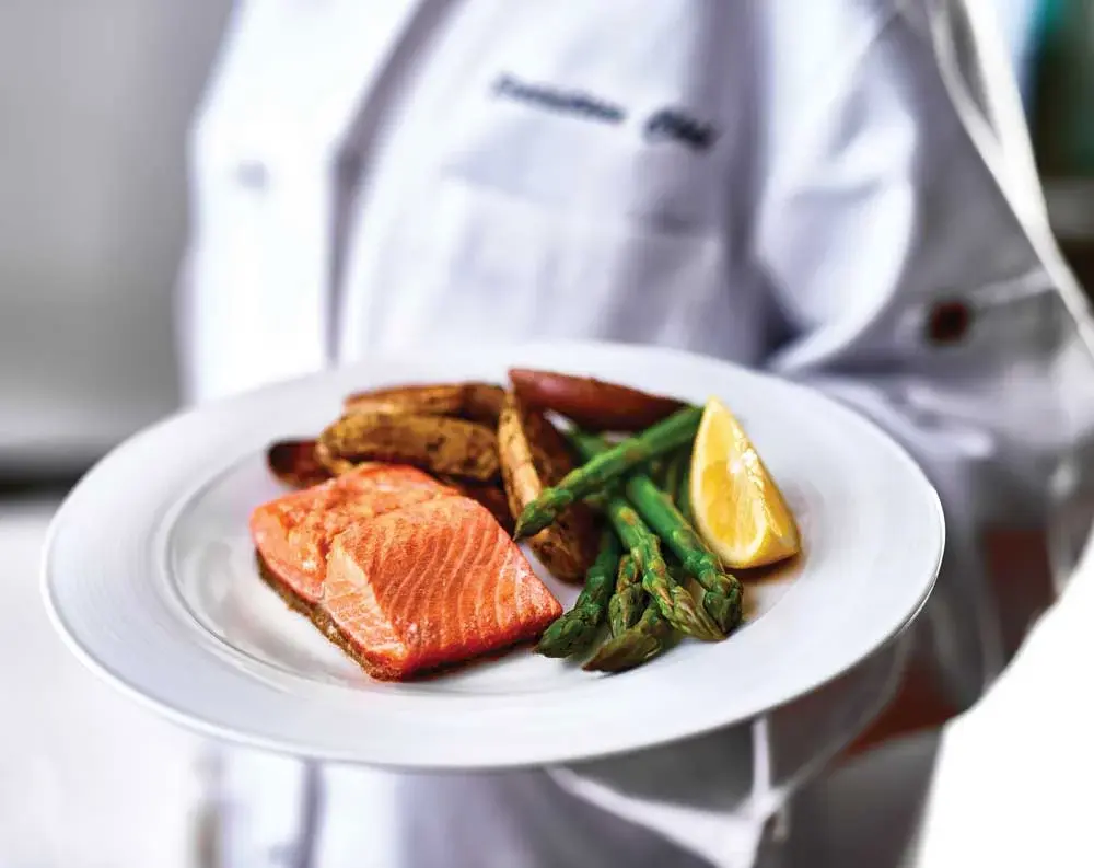 Summerville Estates Chef Created Meals, chef delivering a finished dish.